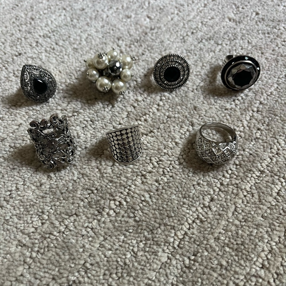Assorted silver tone and one sterling silver rings, size 6.5-7